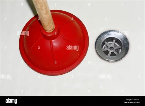 A plunger and drain Stock Photo - Alamy