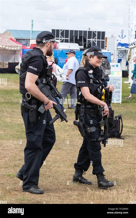 British armed police officers policing an outdoor event Stock Photo - Alamy