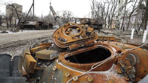 The turret of a T-64 tank destroyed in Ukraine rests a considerable ...