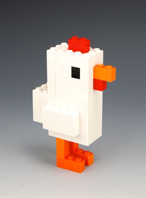 an orange and white lego duck on a gray background