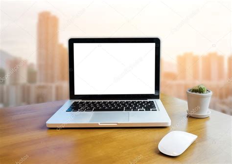 Front view of laptop on table in Office and building blurred background ...