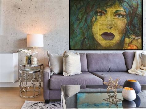 a living room filled with furniture and a painting hanging on the wall over a coffee table