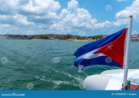 Cuba Flag Waving on Boat at Sea Near Cuban Coastline Stock Photo ...