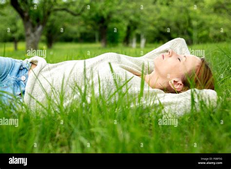 beautiful girl lying down of grass Stock Photo - Alamy