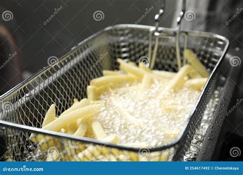 Cooking Delicious French Fries in Hot Oil, Closeup Stock Photo - Image ...