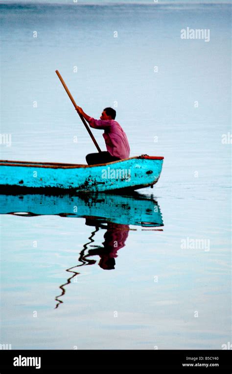 Boat being punted at sunset on Lake Peten Itza, Flores, near Tikal, Guatemala Stock Photo - Alamy