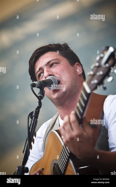 Marcus Mumford of the band Mumford & Sons plays guitar and sings vocals ...