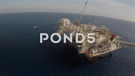 an oil rig in the middle of the ocean with words that read pond5 above it