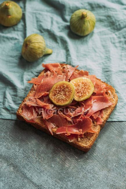 Delicious toast of Iberico ham, cheese and fresh figs on the blue ...