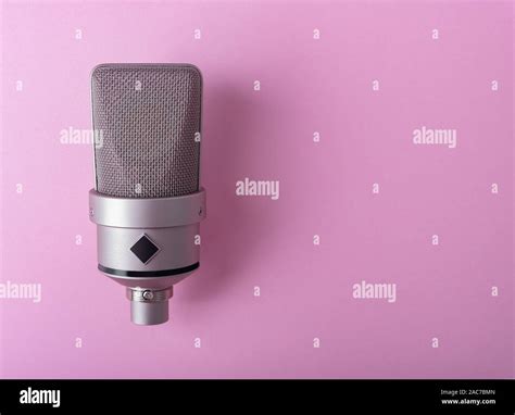 Large diaphragm condenser studio microphone. On purple background Stock Photo - Alamy