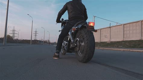 Young man doing a tire burnout on motorcycle on the road at sunset, slow motion Stock Video ...