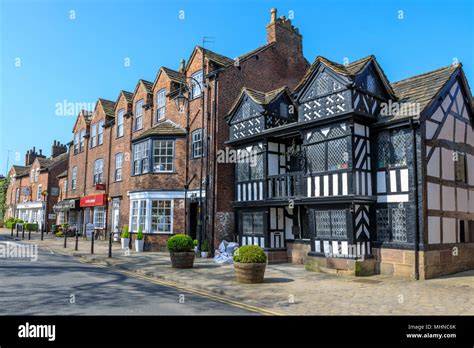 Old timber framed buildings in the main street of historic Prestbury a ...