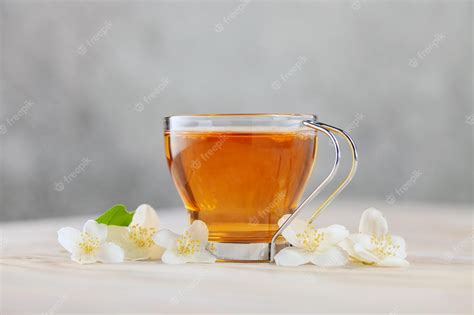 Premium Photo | Tea with jasmine in a glass cup ceremony concept