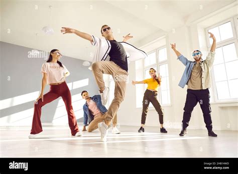 Cool male dancer doing ballet tip toe turn during break dance practice ...