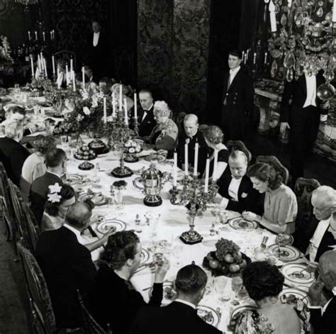 A photo of a lavish dinner shared amongst wealthy men and their wives ...