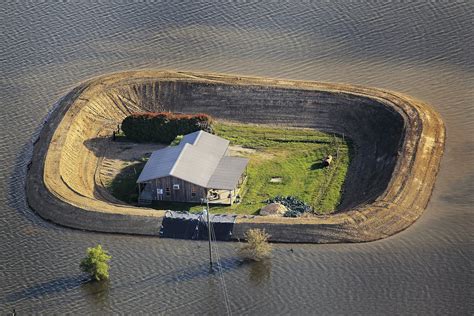 Fortified by a levee, a house near Vicksburg survives a Yazoo River flood in May 2011. : r ...