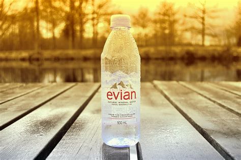 HD wallpaper: 500 ml Evian water bottle on brown wooden surface, still, drink | Wallpaper Flare