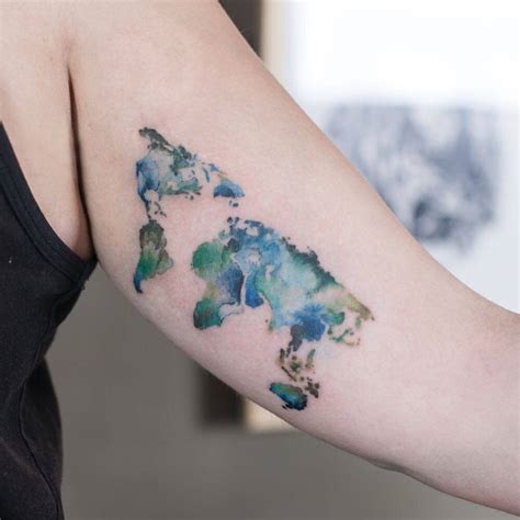 Watercolor style world map tattoo.