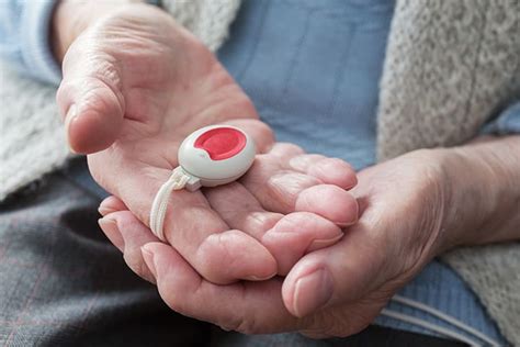 elderly person with emergency button - Comfort Home Care