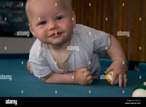 Baby playing on a pool table Stock Photo - Alamy