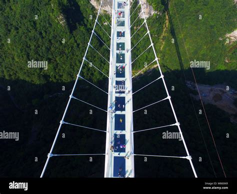 Aerial view of the world's longest and highest glass-bottomed bridge over the Zhangjiajie Grand ...