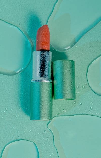 Premium Photo | Waterproof red lipstick on a green background