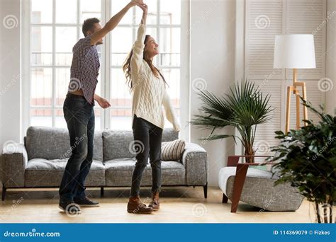 Happy Romantic Couple Dancing In Living Room At Home Together Stock ...