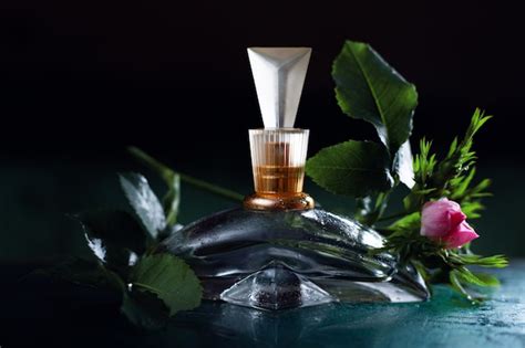 Premium Photo | Women's perfume and flowers on a dark background