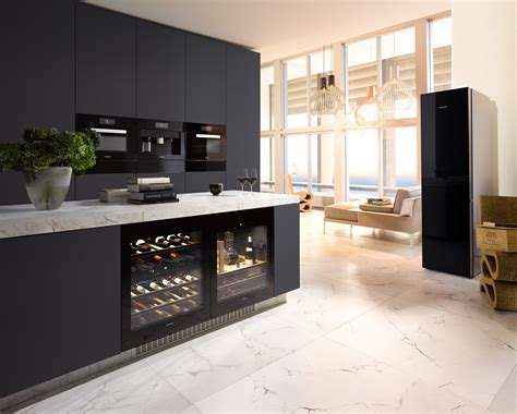 a kitchen with marble counter tops and an open wine cooler in the center, next to a dining room ...