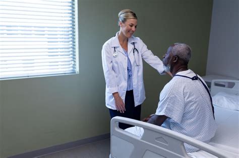 Premium Photo | Caucasian female doctor smiling to african american ...