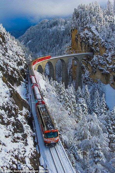 The Bernina Express adds a splash of red to snow-covered Switzerland ...