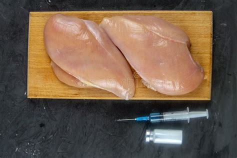 Injection Syringe in Raw Chicken Pieces, Concept of Injection of GMOs ...