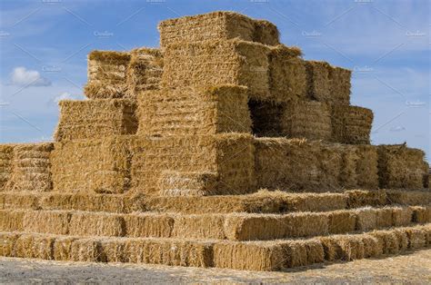 Large stack of square hay bales | Nature Stock Photos ~ Creative Market
