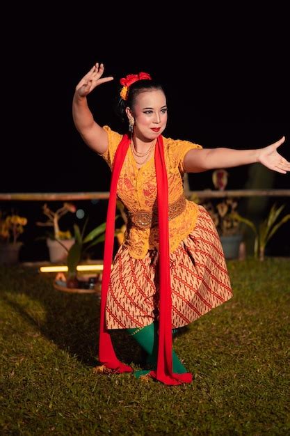 Premium Photo | Balinese dancer with an orange costume and wearing ...