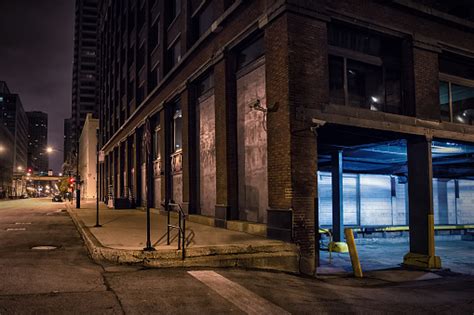 Dark City Downtown Street Corner With An Industrial Warehouse Loading Dock At Night Stock Photo ...