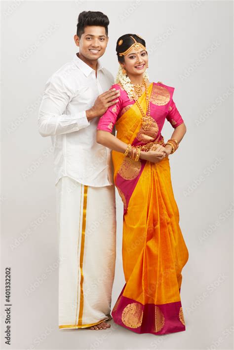 Attractive happy south Indian couple in traditional dress on white ...