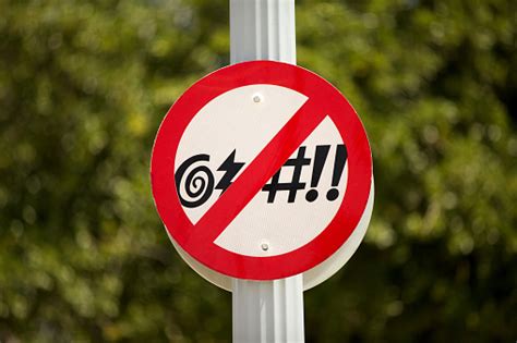 No Cursing Street Sign In Front Of A Green Bush Stock Photo - Download ...