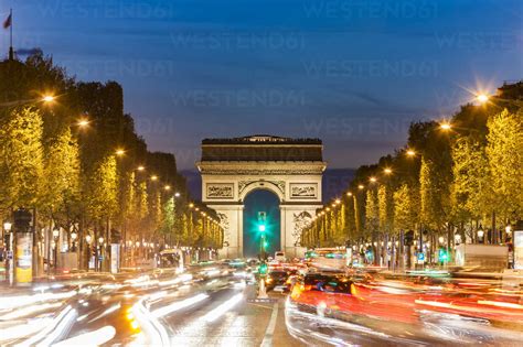 France, Paris, Champs-Elysees, Arc de Triomphe and cars at night with light trails stock photo