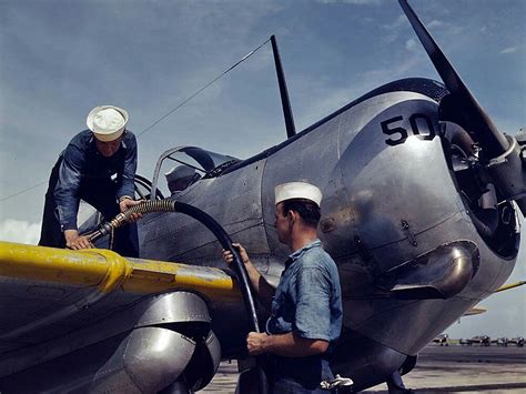 U.S. Navy mechanics at Naval Air Station Corpus Christi, Texas refuel a Curtiss SNC-1 Falcon ...