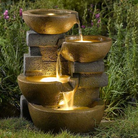 Showcasing a cascading bowl design, this eye-catching fountain lends a touch of rustic grace t ...