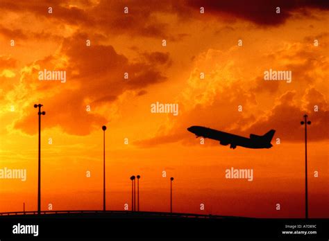 airplane taking off in sunset FAA Stock Photo - Alamy