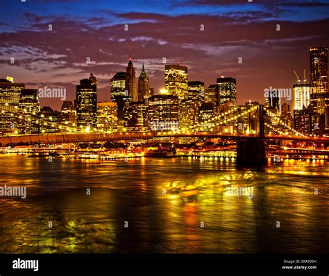 Historic Brooklyn Bridge and lower Manhattan reflected in East River Stock Photo - Alamy