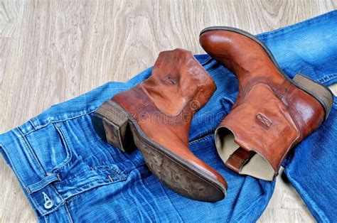 Brown Cowboy Boots on Blue Jeans Stock Photo - Image of clothing, denim: 104267566