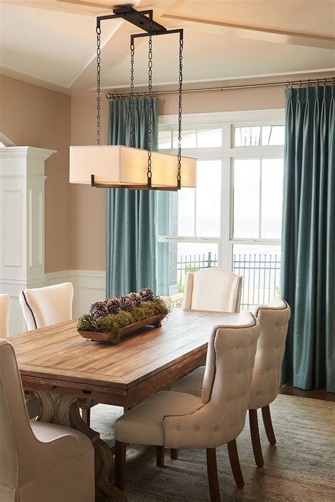 If you have a long dining room table, try using a linear chandelier to light it. Look for ones ...