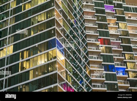 Facade of a high-rise apartment building at night Stock Photo - Alamy