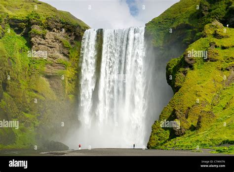 Tourists at Skogar waterfall in southwest Iceland Stock Photo - Alamy