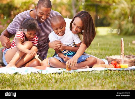 Family Having Picnic In Garden Together Stock Photo - Alamy