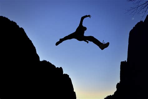 Man Jump Through The Gap Stock Photo - Download Image Now - iStock