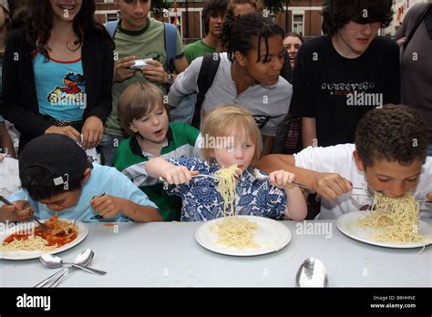 Children take part in a spaghetti eating contest Stock Photo - Alamy