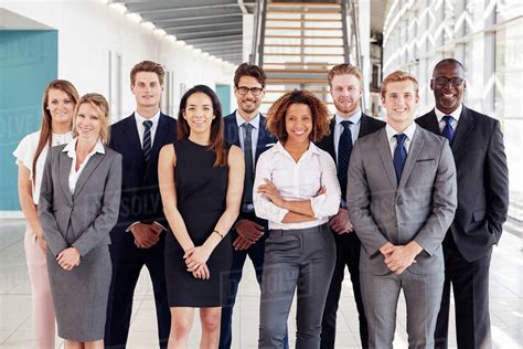 Office workers in a modern lobby, group portrait - Stock Photo - Dissolve